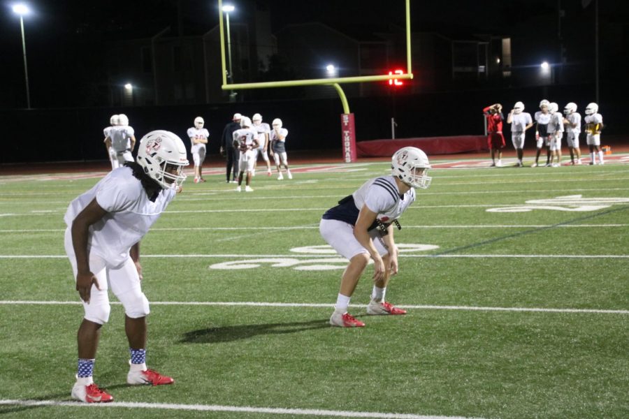 Practicing under Friday-night-light conditions, Cooper Thomas ’20 and Ian Wheeler ’19 are working on their linebacker reads and first-steps. Wheeler has stepped in as linebacker and will play both sides of the ball, continuing his position as starting running back.