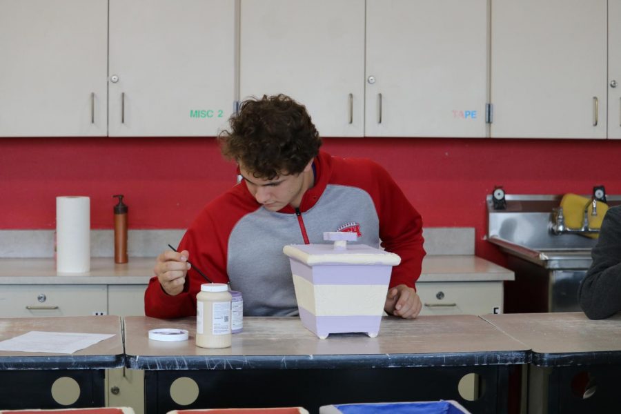 Daniel Coco ‘20 puts the finishing touches on the handle to his lid.  “I like to think of myself as the modern day Michelangelo.  Occasionally, I will get frustrated with my piece but Mr. Nebel is always able to show me how to fix it” Coco says.