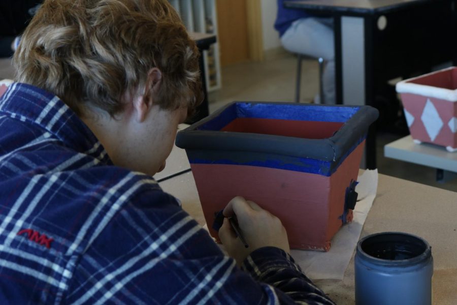 Kevin Delia ’20 prepares his piece for his final coat of paint.  “I enjoyed doing the many different projects that we had this semester.  Ceramics is definitely a class I will look back upon and smile” said Delia.                                                                                                                                           