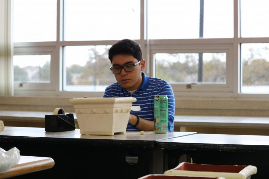 David Rodriguez ‘20 focuses hard on glazing his piece.  “I am very proud of my piece.  I put in many hours of hard work and I think it is paying off” said Rodriguez.