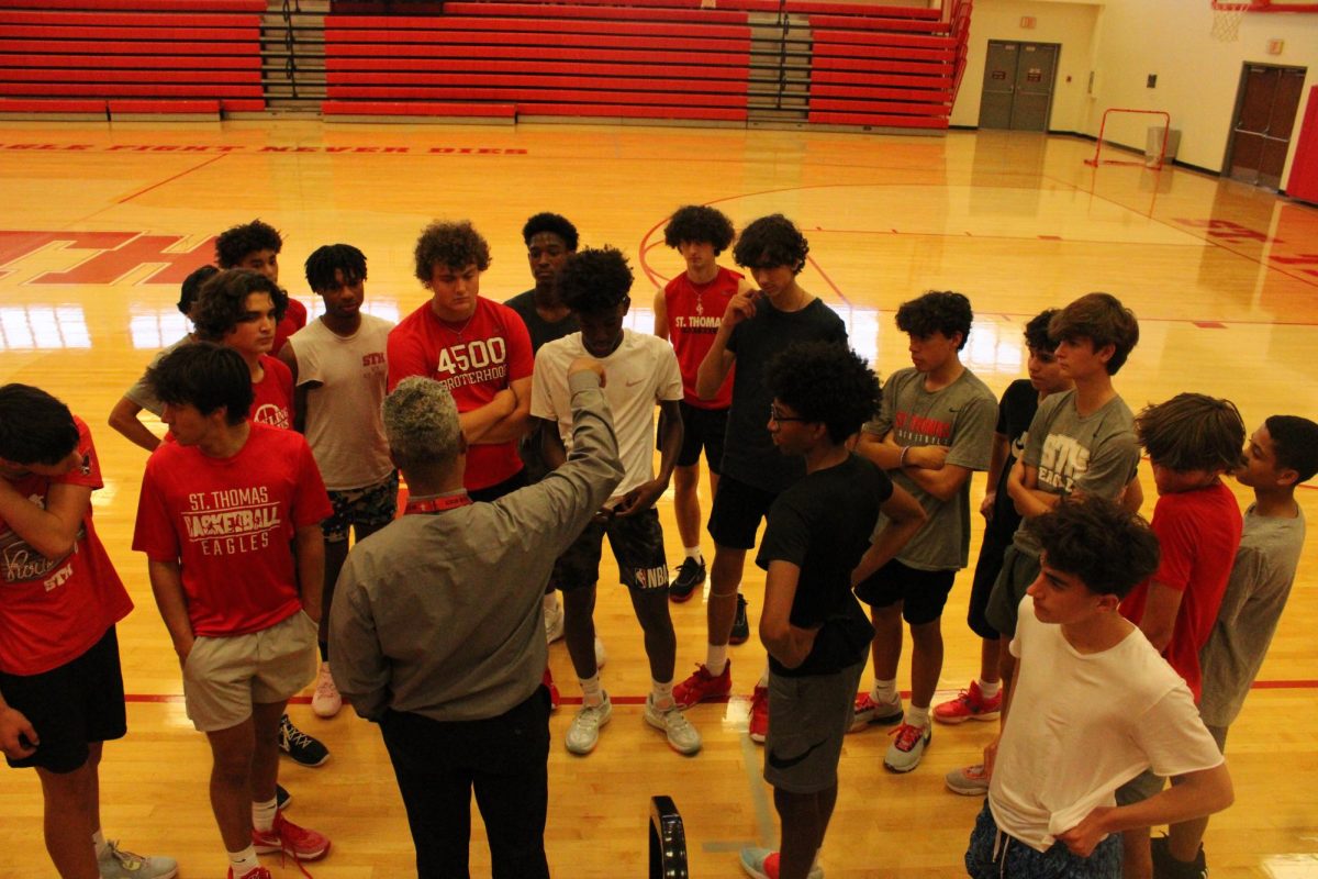 Coach+Jerome+Llorens+addresses+the+team+after+their+scrimmage+with+Emery.+